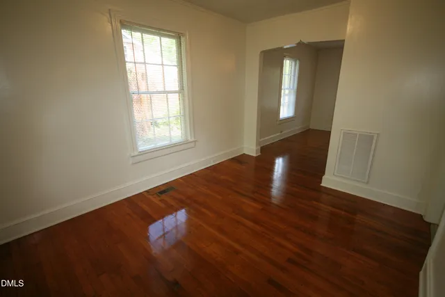 wooden floor in an empty room with a window