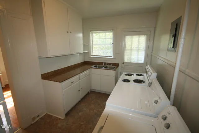 a kitchen with a refrigerator and a stove