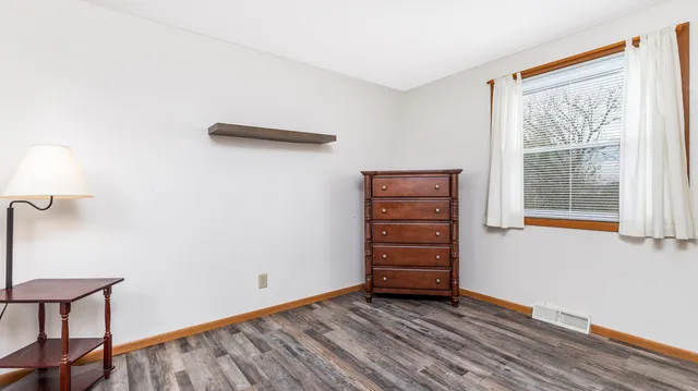 a view of room with window and wooden floor