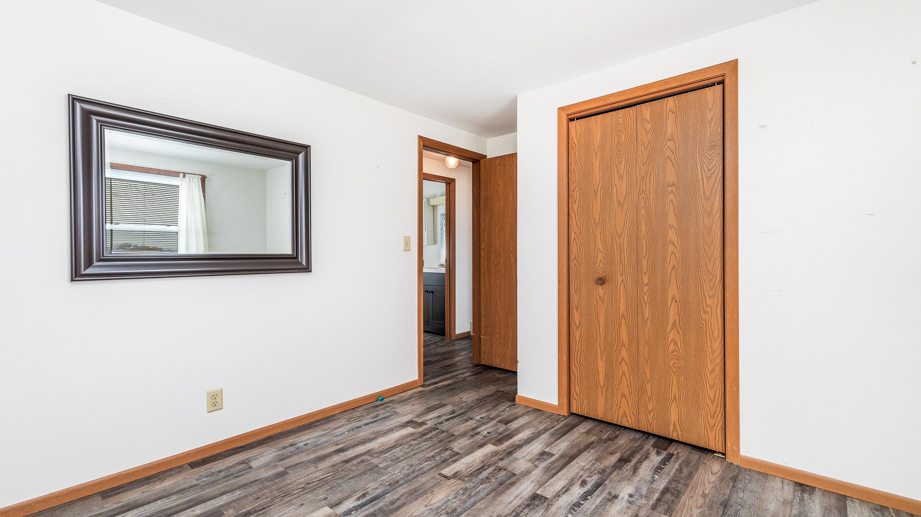 10-a125 E Apple Canyon Road Apple River, IL 61001 - Photo 12 of 29 a view of an empty room with wooden floor and closet