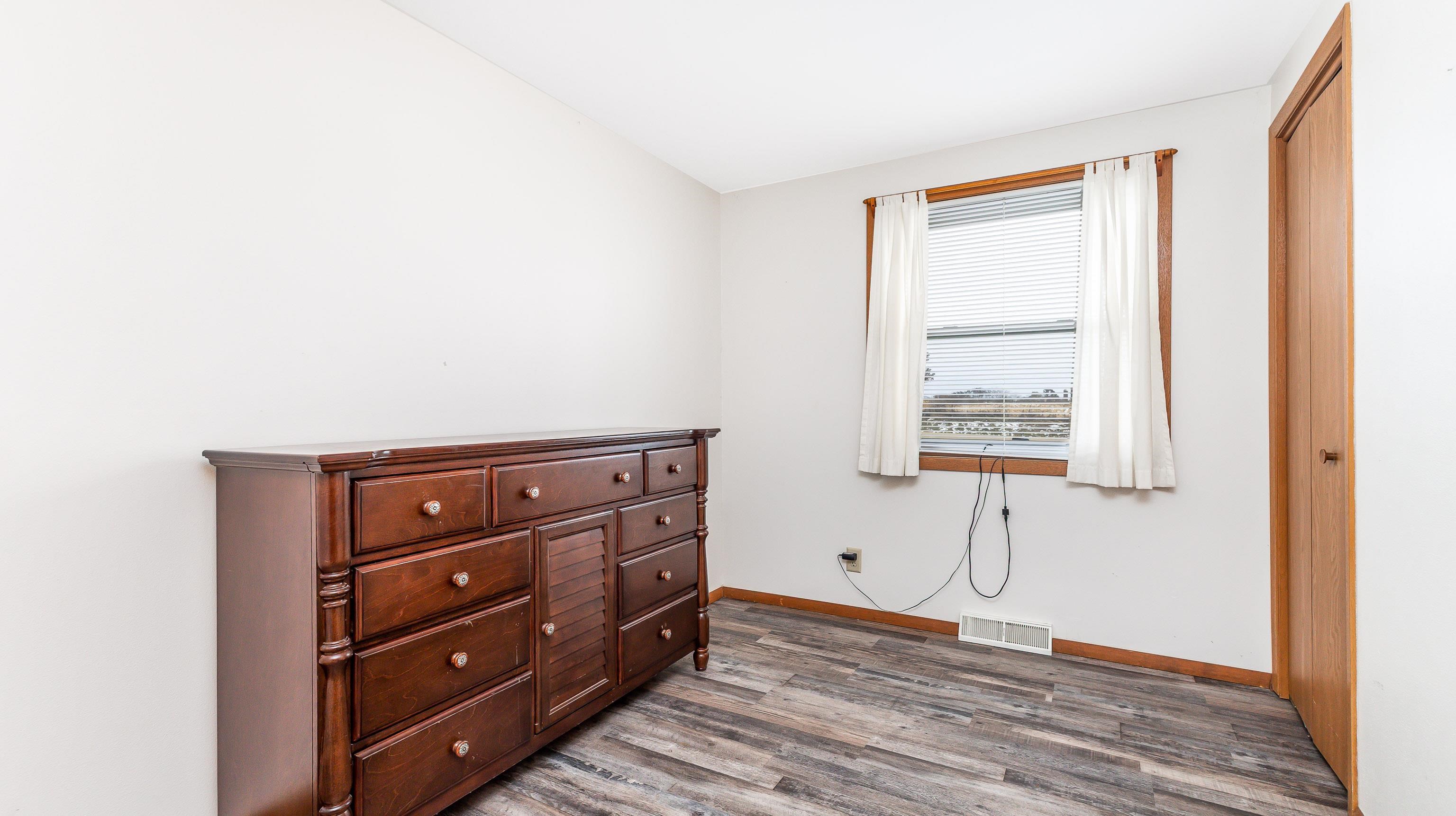 10-a125 E Apple Canyon Road Apple River, IL 61001 - Photo 14 of 29 a room with a dresser and a window