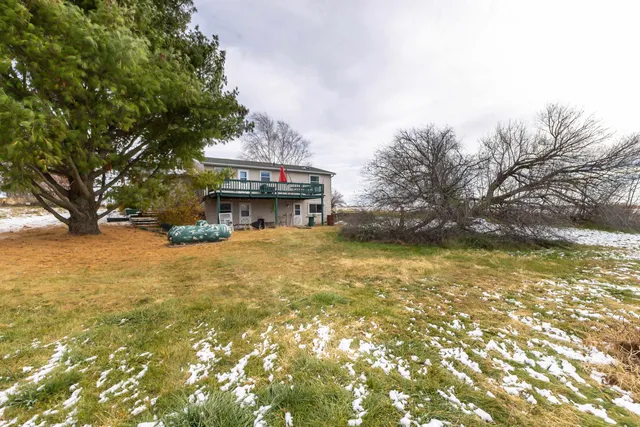 a view of swimming pool with lawn chairs and iron fence