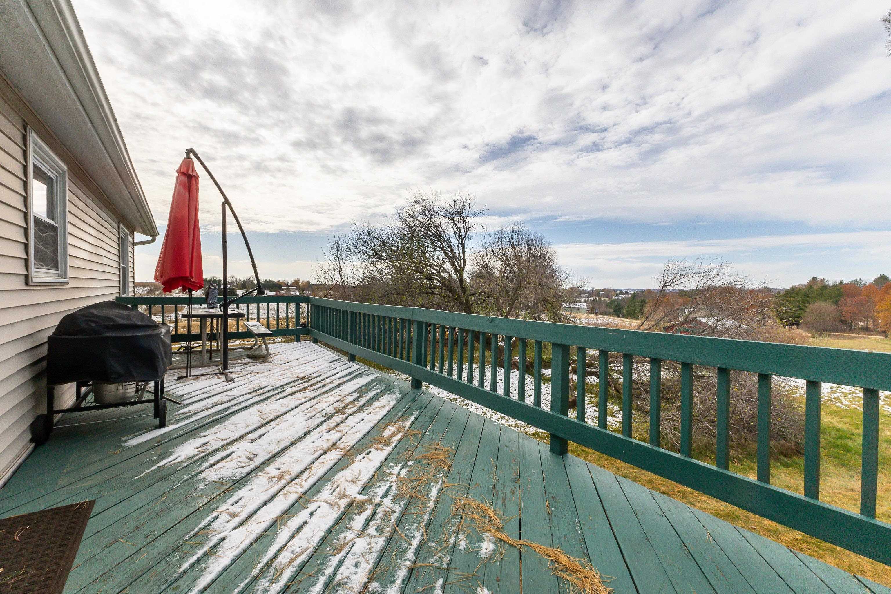 10-a125 E Apple Canyon Road Apple River, IL 61001 - Photo 26 of 29 a view of a balcony with wooden floor and iron stairs