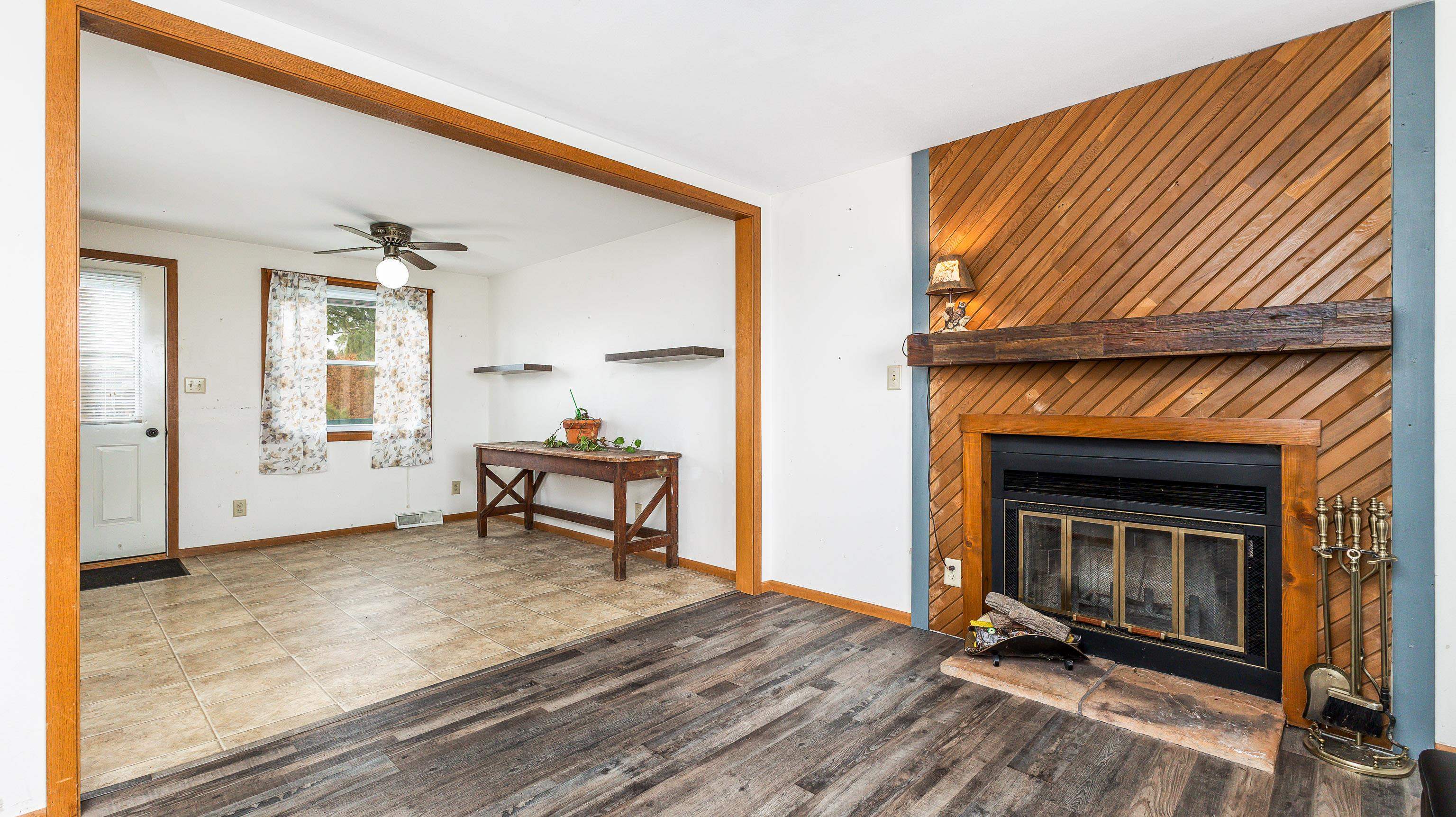10-a125 E Apple Canyon Road Apple River, IL 61001 - Photo 3 of 29 a living room with a fireplace furniture a ceiling fan and a wooden floor