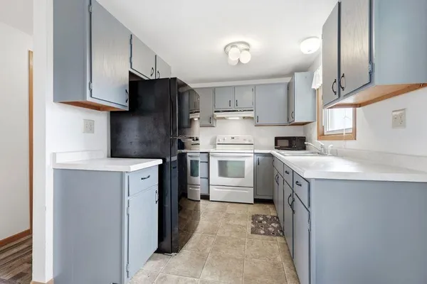 a view of an empty room with wooden floor and closet