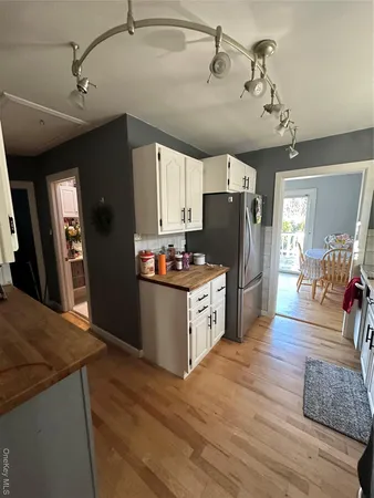 a kitchen with granite countertop a refrigerator and a stove top oven