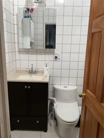 a bathroom with a sink toilet and mirror
