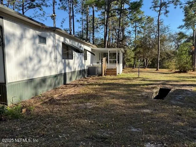a backyard of a house with a yard and outdoor seating