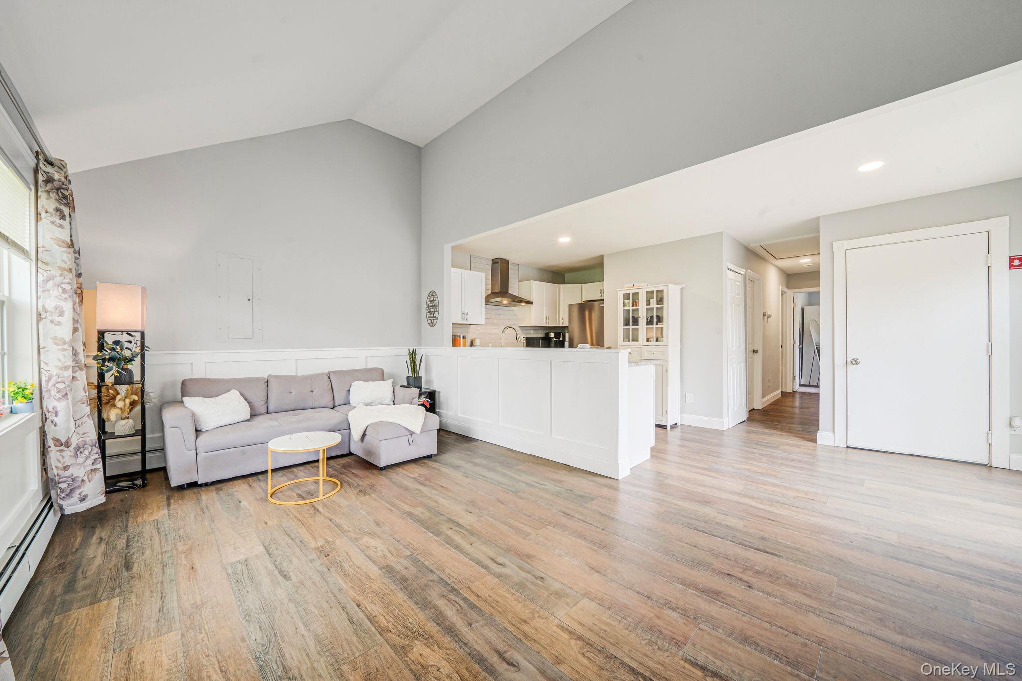 332 Commack Road Shirley, NY 11967 - Photo 7 of 25 a living room with furniture and a wooden floor
