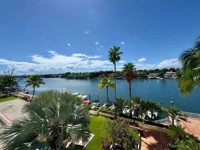 a view of a lake with a houses in a back yard