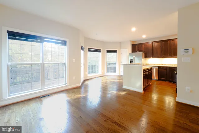 a kitchen with wooden cabinets a refrigerator and a sink