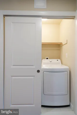 a bathroom with a granite countertop sink a toilet and a mirror