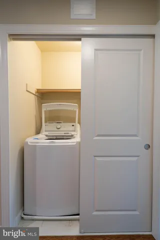 a white bath tub sitting next to a shower