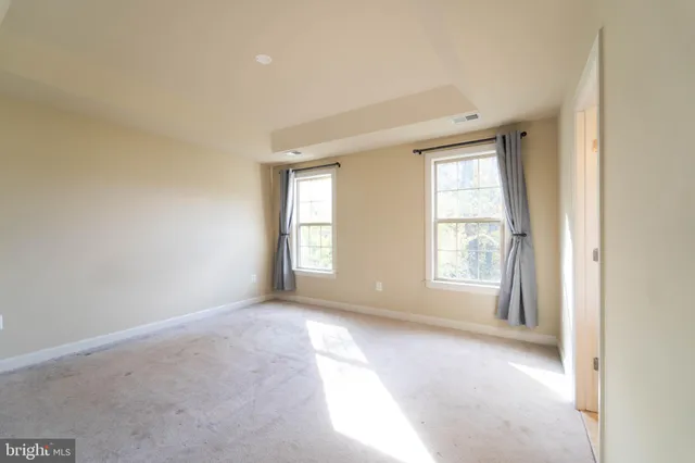 a bathroom with a granite countertop double vanity sink and a mirror