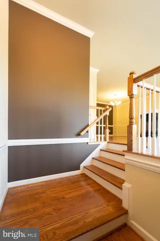 a view of a room with wooden floor and a window