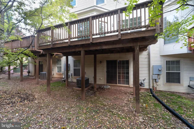 a view of front door with wooden floor and fence