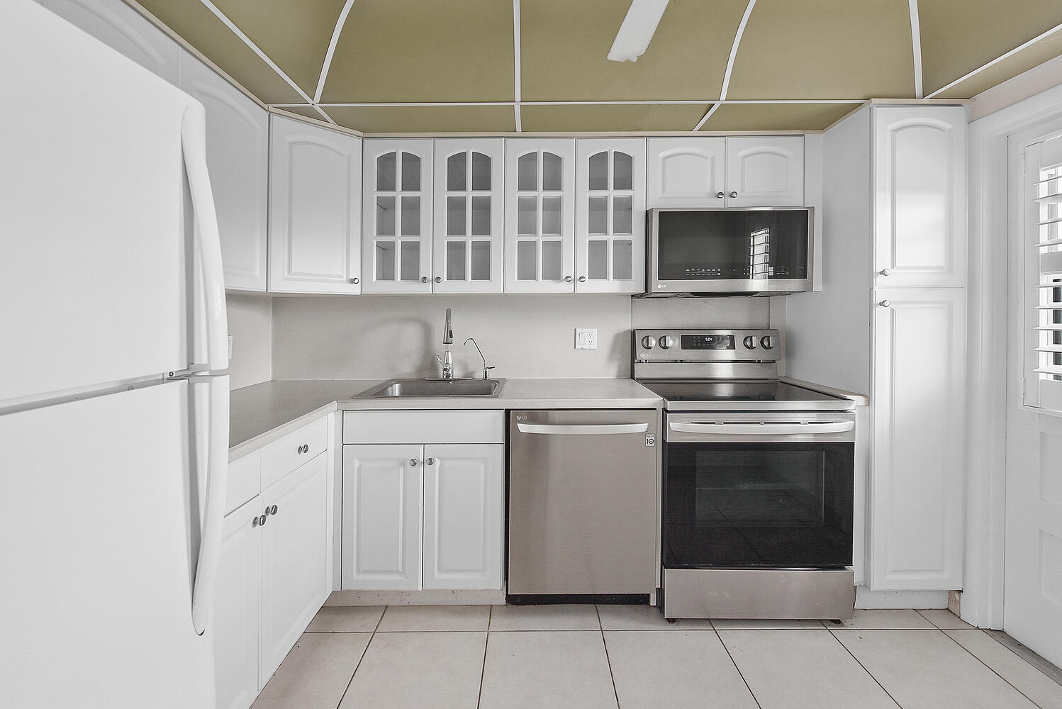 2871 North Ocean Boulevard, Unit F429 Boca Raton, FL 33431 - Photo 10 of 38 a kitchen with stainless steel appliances granite countertop a sink and a microwave