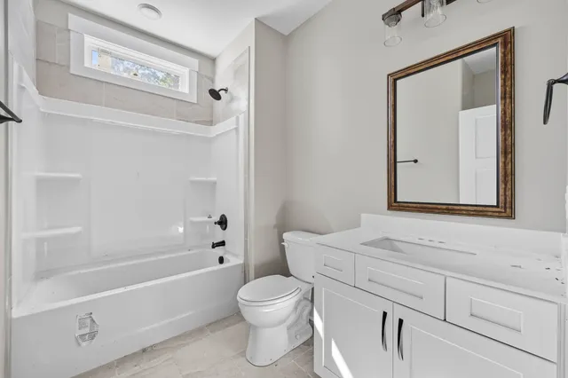 a bathroom with a toilet a sink and a bathtub