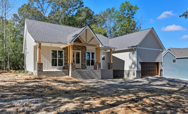 a front view of a house with a garden