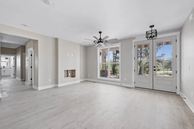 a view of a room with window and a ceiling fan