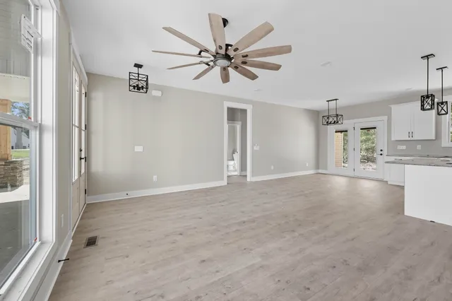 a view of a kitchen with a sink and a ceiling fan