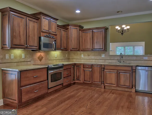 a kitchen with granite countertop wooden cabinets a sink and dishwasher