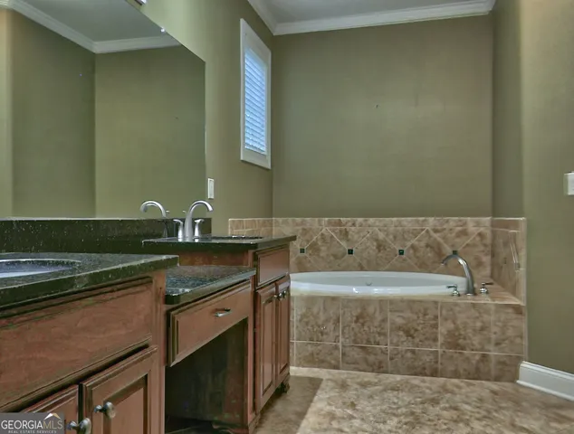 a bathroom with a granite countertop sink and a bathtub