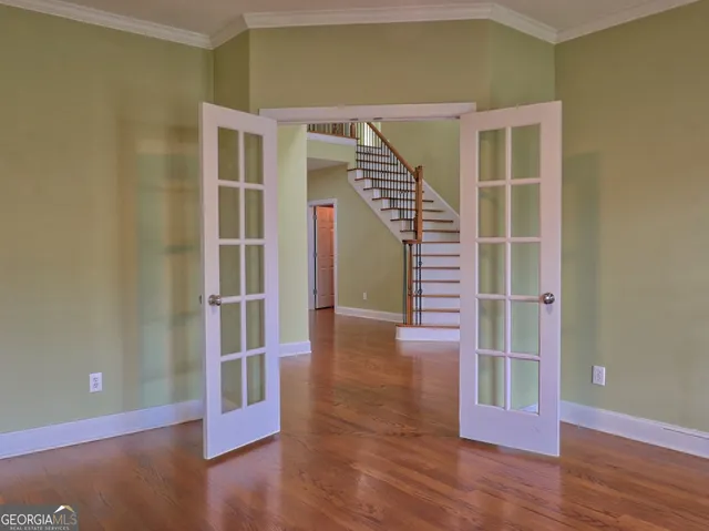 a view of entryway and hall with wooden floor