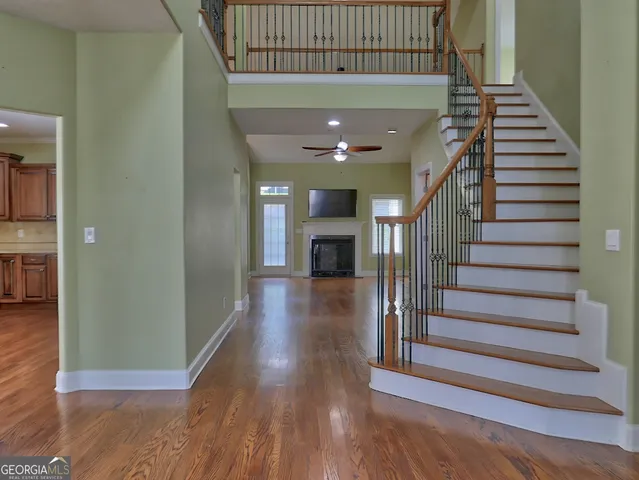 a view of entryway and hall with wooden floor