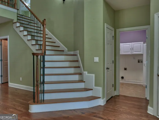 a view of entryway with wooden floor and stairs