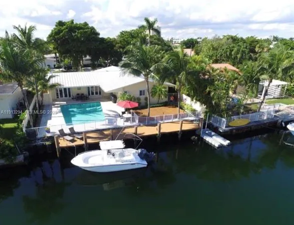 a swimming pool with outdoor seating and a garden