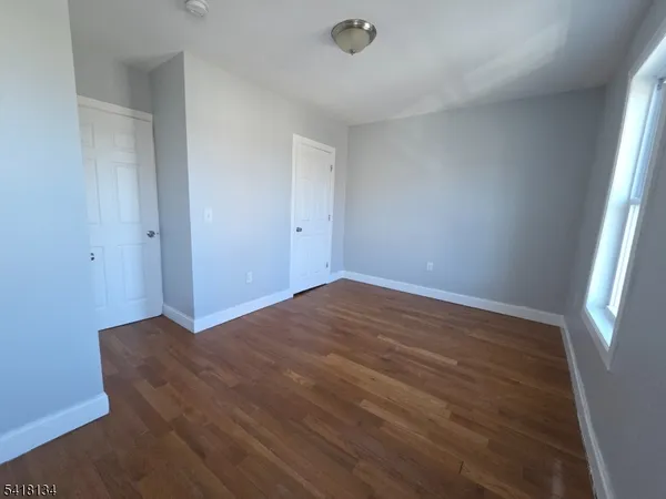 a view of an empty room and wooden floor