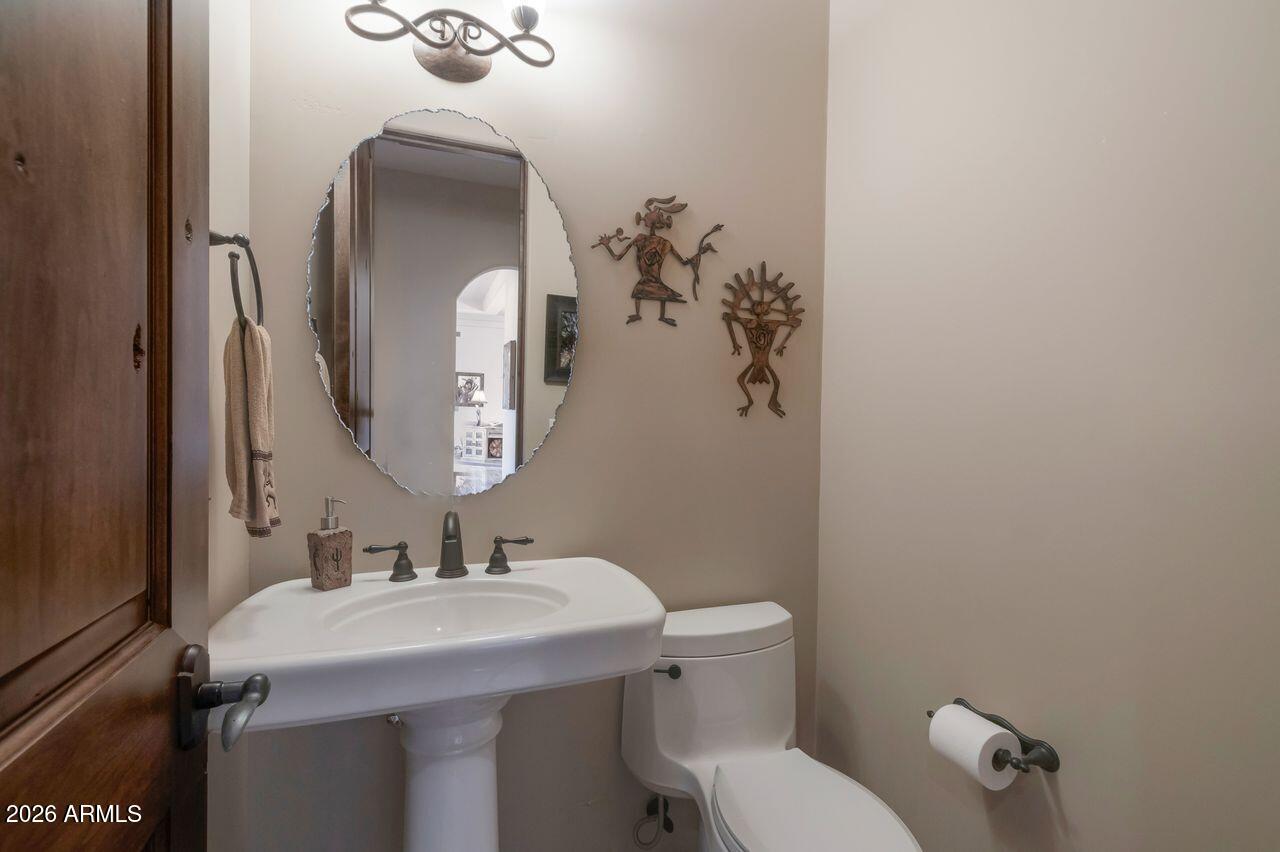 18507 East Picacho Road Rio Verde, AZ 85263 - Photo 21 of 33 a bathroom with a toilet sink and mirror
