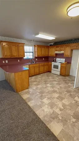 a view of a livingroom with a kitchen