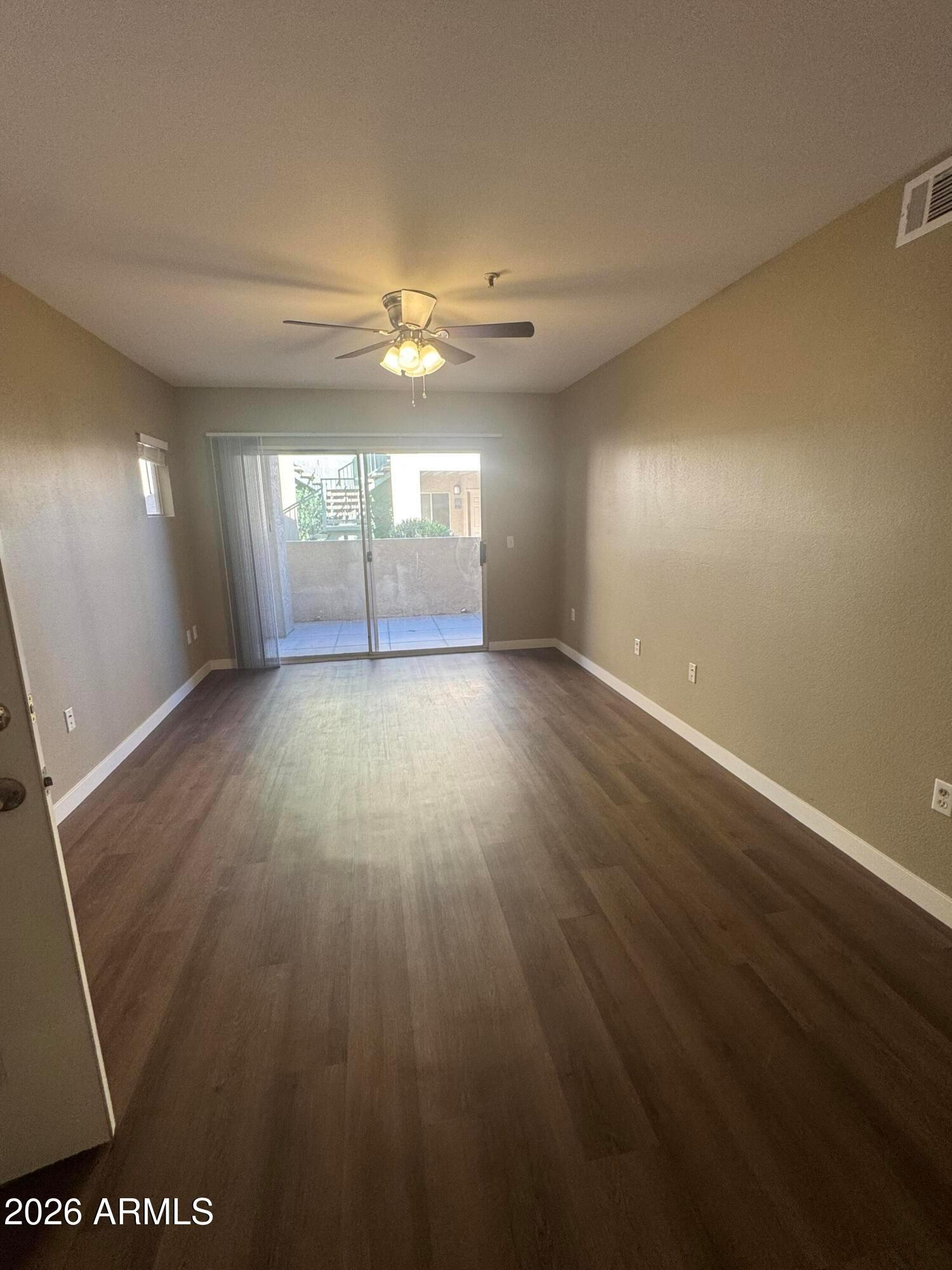 wooden floor in an empty room with a window