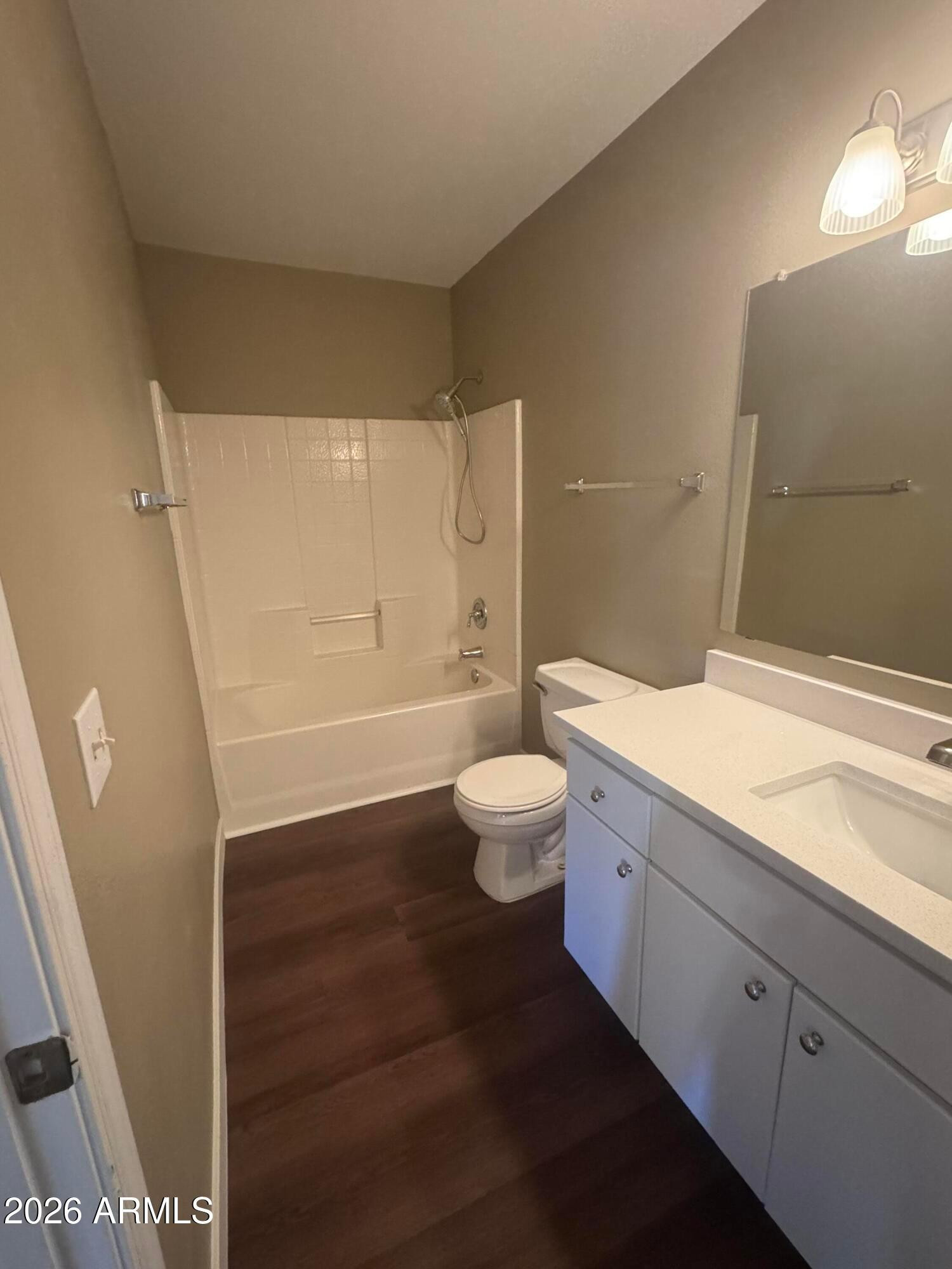 1295 North Ash Street, Unit 612 Gilbert, AZ 85233 - Photo 2 of 10 a bathroom with a granite countertop sink a toilet a mirror and shower