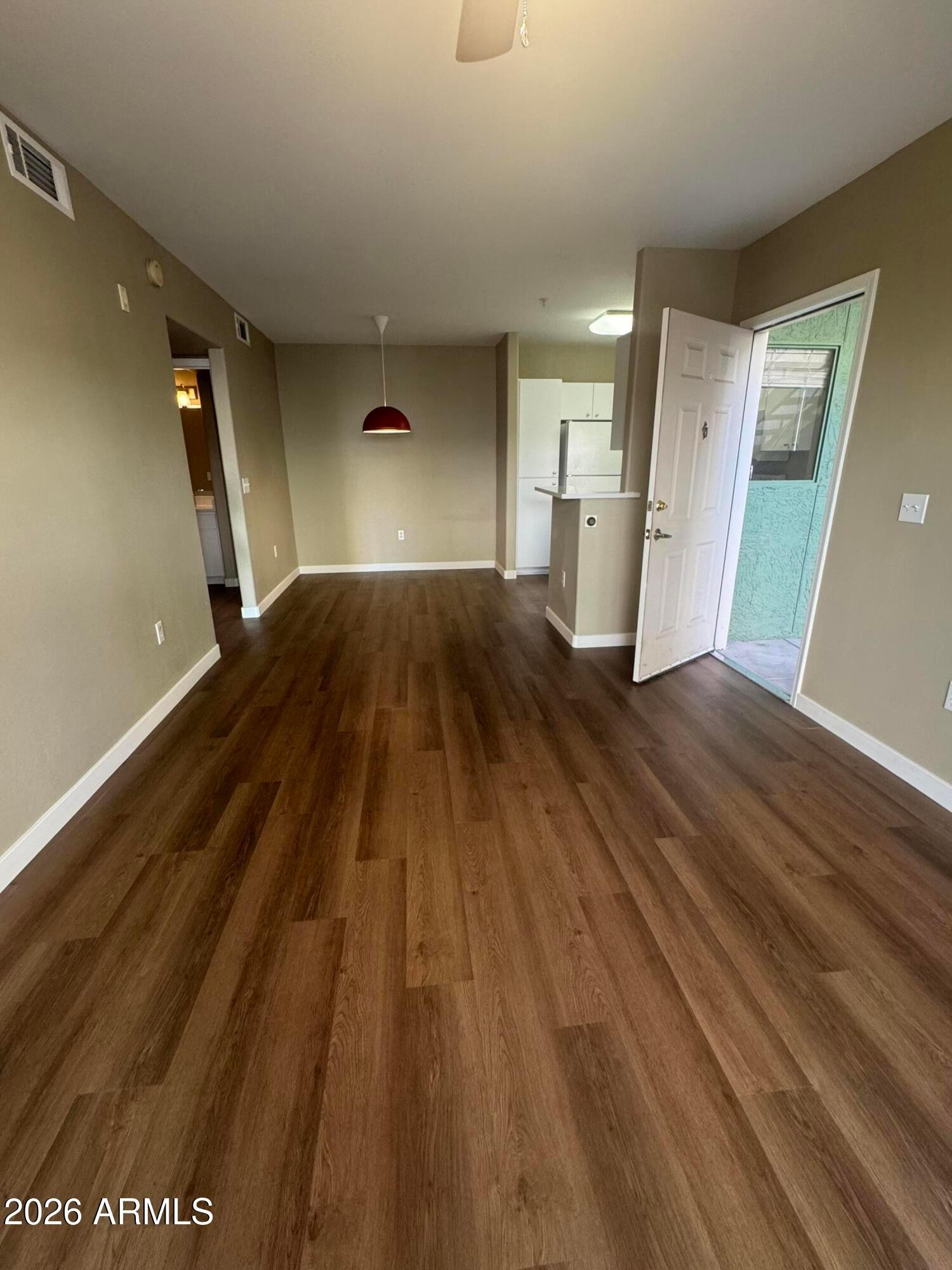 1295 North Ash Street, Unit 612 Gilbert, AZ 85233 - Photo 6 of 10 a view of a room with wooden floor and staircase
