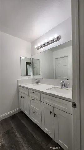 a view of a hallway with wooden floor and entryway