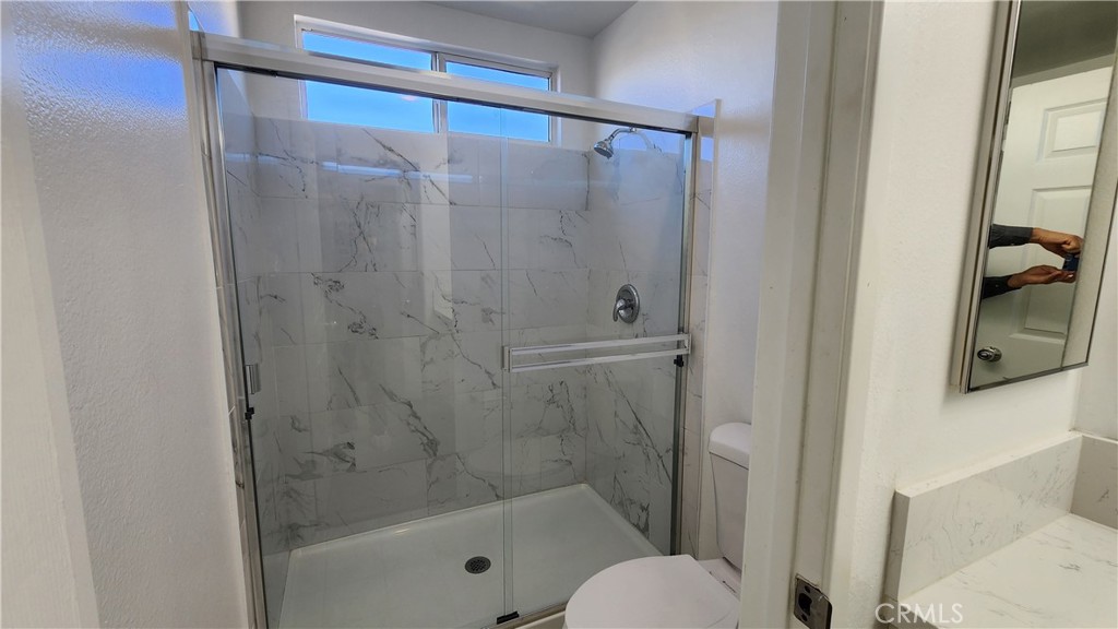 1496 Dusty Hill Road Hemet, CA 92545 - Photo 18 of 31 a bathroom with a shower and toilet