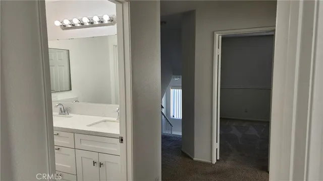 a bathroom with a double vanity sink and a mirror