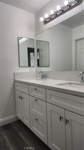 a bathroom with a sink vanity and mirror