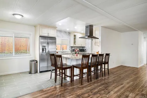 a kitchen with a refrigerator and microwave