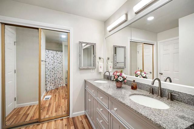 a kitchen with a sink and flowers