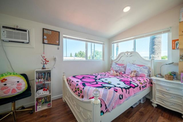 a bedroom with a bed a window and dresser