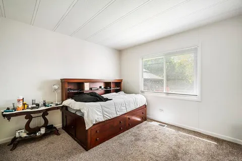 a living room with furniture a window and gym equipment
