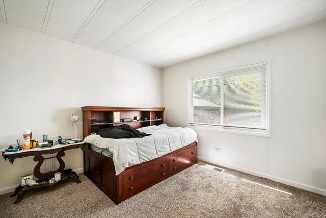 a living room with furniture a window and gym equipment