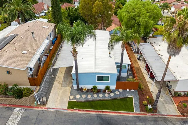 front view of house with a yard and potted plants