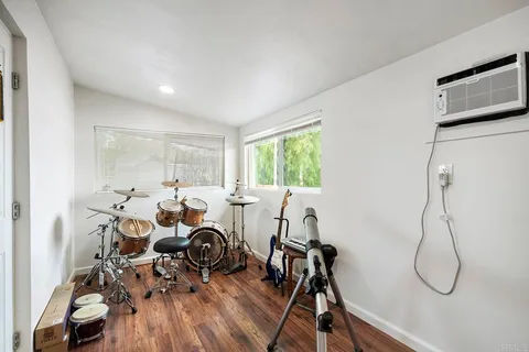 a view of a chair and table in backyard of the house