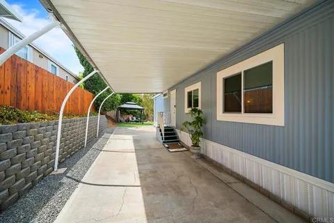 a backyard of a house with table and chairs