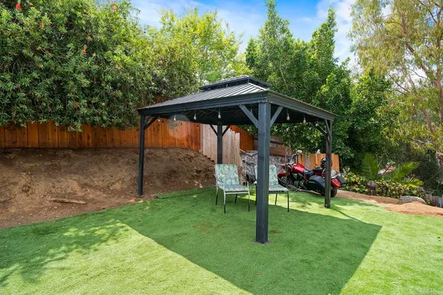 a backyard of a house with yard and outdoor seating